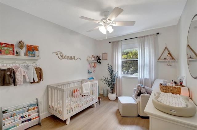 4413 NW 97th Pl, Doral, FL 33178 - bedroom featuring a nursery area, light wood-style floors, and ceiling fan