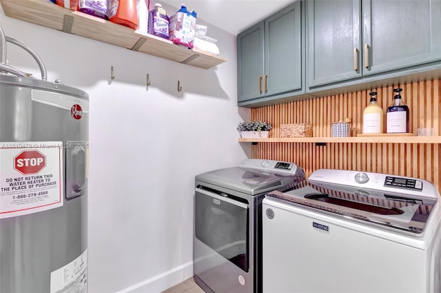 4413 NW 97th Pl, Doral, FL 33178 - laundry area with electric water heater, cabinet space, and washer and dryer