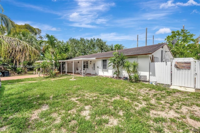 4035 N 110th Ave N, West Palm Beach, FL 33411 - rear view of house featuring a gate, stucco siding, and a patio