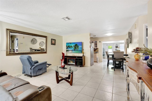 4035 N 110th Ave N, West Palm Beach, FL 33411 - living room with light tile patterned flooring, a textured ceiling, and baseboards