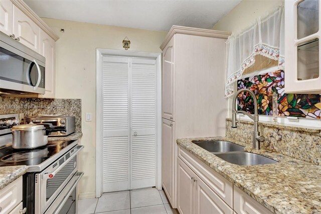 4035 N 110th Ave N, West Palm Beach, FL 33411 - kitchen with stainless steel appliances, a sink, decorative backsplash, and light tile patterned flooring