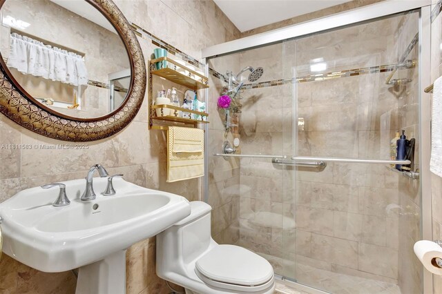 4035 N 110th Ave N, West Palm Beach, FL 33411 - bathroom with tile walls, a shower stall, toilet, and a sink