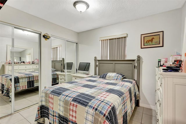 4035 N 110th Ave N, West Palm Beach, FL 33411 - bedroom with light tile patterned flooring, a closet, and a textured ceiling