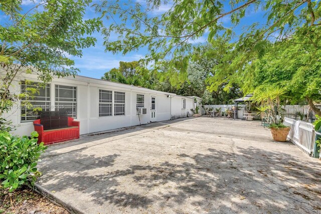 4035 N 110th Ave N, West Palm Beach, FL 33411 - rear view of house featuring a patio and stucco siding