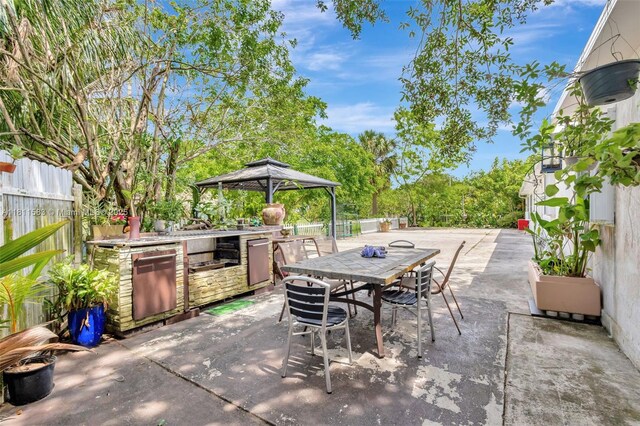 4035 N 110th Ave N, West Palm Beach, FL 33411 - view of patio / terrace with exterior kitchen, a gazebo, and outdoor dining space