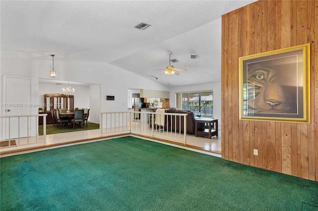 988 NW 110th Ave, Coral Springs, FL 33071 - living room featuring wood walls, carpet flooring, lofted ceiling, a ceiling fan, and a textured ceiling