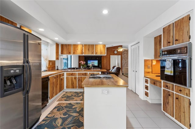 988 NW 110th Ave, Coral Springs, FL 33071 - kitchen with black appliances, recessed lighting, tasteful backsplash, light tile patterned flooring, and brown cabinetry