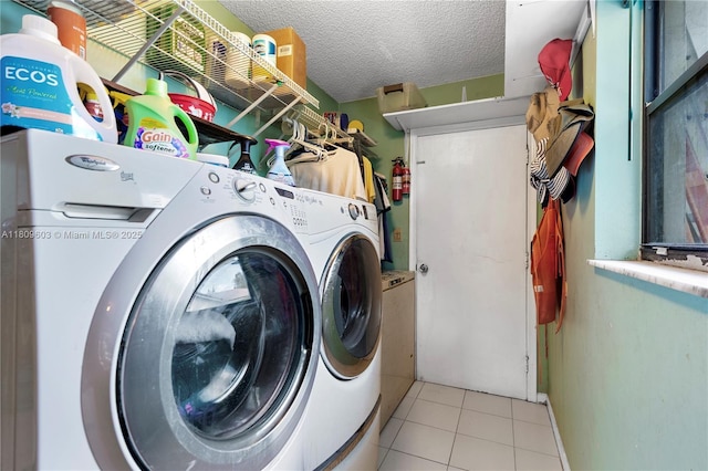 988 NW 110th Ave, Coral Springs, FL 33071 - washroom with washer and clothes dryer, light tile patterned floors, and a textured ceiling