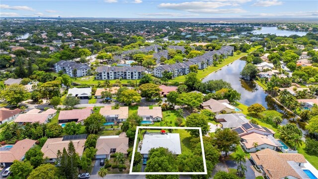 988 NW 110th Ave, Coral Springs, FL 33071 - aerial view of residential area featuring property boundaries highlighted and a large body of water