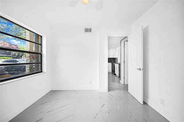 132 S Cypress Rd Unit 518, Pompano Beach, FL 33060 - empty room with marble finish floors and ceiling fan