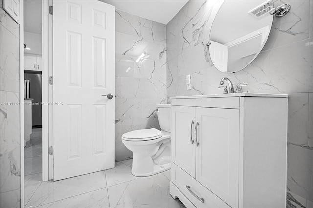 132 S Cypress Rd Unit 518, Pompano Beach, FL 33060 - bathroom featuring tile walls, marble tiled flooring, vanity, and stone wall