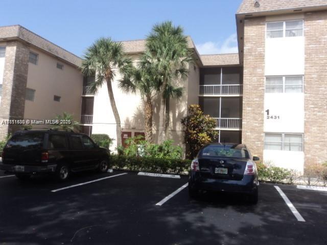 2431 SW 82nd Ave Unit 205, Davie, FL 33324 - view of building exterior featuring uncovered parking