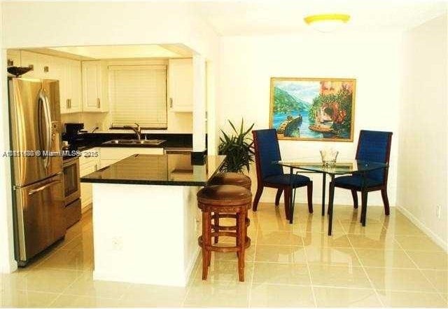 2431 SW 82nd Ave Unit 205, Davie, FL 33324 - kitchen with stainless steel appliances, a sink, dark countertops, and light tile patterned floors