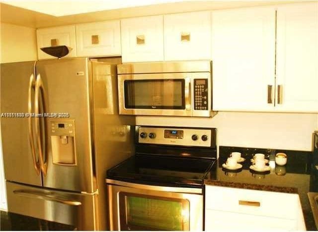 2431 SW 82nd Ave Unit 205, Davie, FL 33324 - kitchen with appliances with stainless steel finishes and white cabinetry