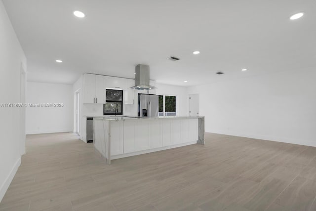 4220 SW 4th St, Plantation, FL 33317 - kitchen with appliances with stainless steel finishes, island exhaust hood, white cabinetry, light countertops, and recessed lighting