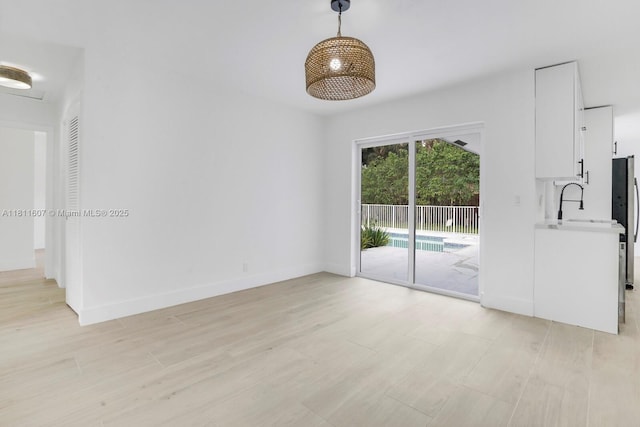 4220 SW 4th St, Plantation, FL 33317 - empty room featuring light wood-style flooring, a sink, and baseboards