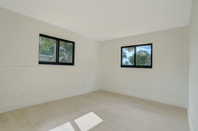 4220 SW 4th St, Plantation, FL 33317 - unfurnished room featuring plenty of natural light, baseboards, and light wood-style flooring
