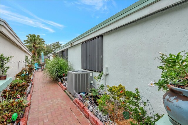 3720 NW 20th St, Coconut Creek, FL 33066 - view of property exterior featuring stucco siding, central air condition unit, and a patio area