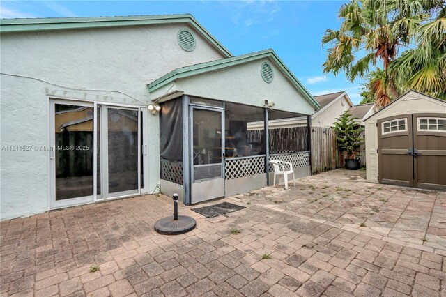 3720 NW 20th St, Coconut Creek, FL 33066 - rear view of house with a patio, a sunroom, and stucco siding