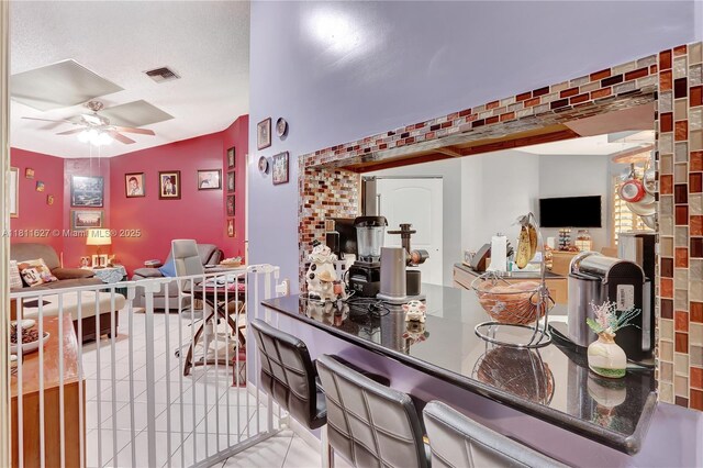 3720 NW 20th St, Coconut Creek, FL 33066 - bar area with ceiling fan, tile patterned flooring, and lofted ceiling