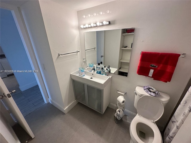 486 NW 165th St Rd Unit B-303, Miami, FL 33169 - bathroom featuring toilet, vanity, baseboards, and tile patterned floors
