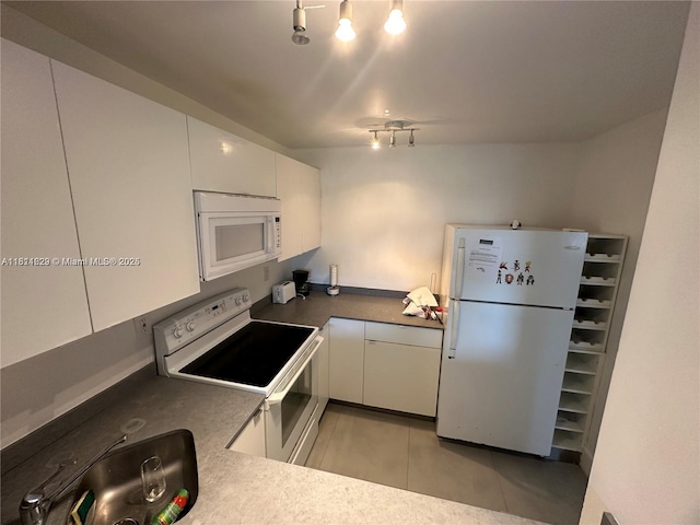 486 NW 165th St Rd Unit B-303, Miami, FL 33169 - kitchen featuring white appliances, white cabinetry, and light tile patterned floors