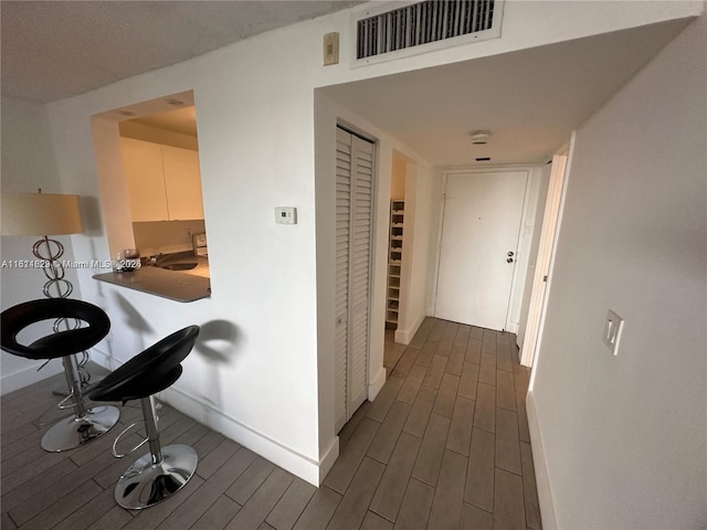 486 NW 165th St Rd Unit B-303, Miami, FL 33169 - hallway with dark wood-style floors and baseboards