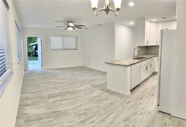 4341 NW 59th St, North Lauderdale, FL 33319 - kitchen with white appliances, ceiling fan, white cabinets, light wood-style flooring, and tasteful backsplash