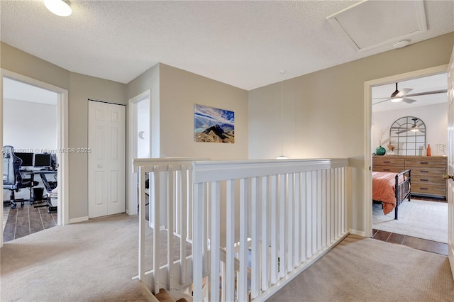 16222 NW 17th Ct, Pembroke Pines, FL 33028 - hallway featuring a textured ceiling, carpet flooring, an office area, baseboards, and wood finished floors