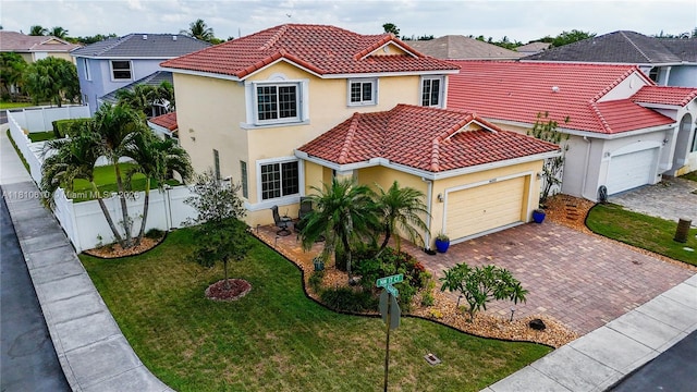 16222 NW 17th Ct, Pembroke Pines, FL 33028 - mediterranean / spanish home featuring a tile roof, stucco siding, an attached garage, and decorative driveway