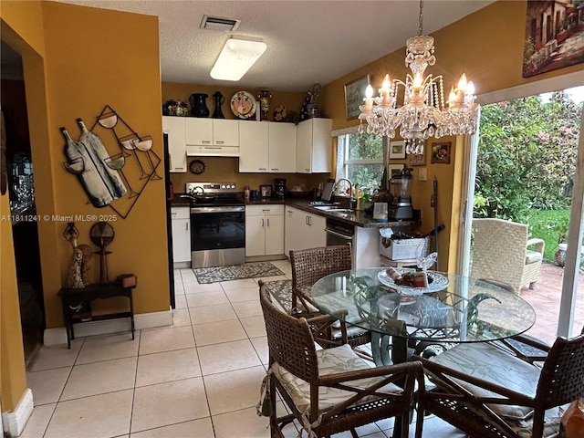11920 SW 20th St, Miramar, FL 33025 - dining room with a chandelier, light tile patterned flooring, baseboards, and a textured ceiling