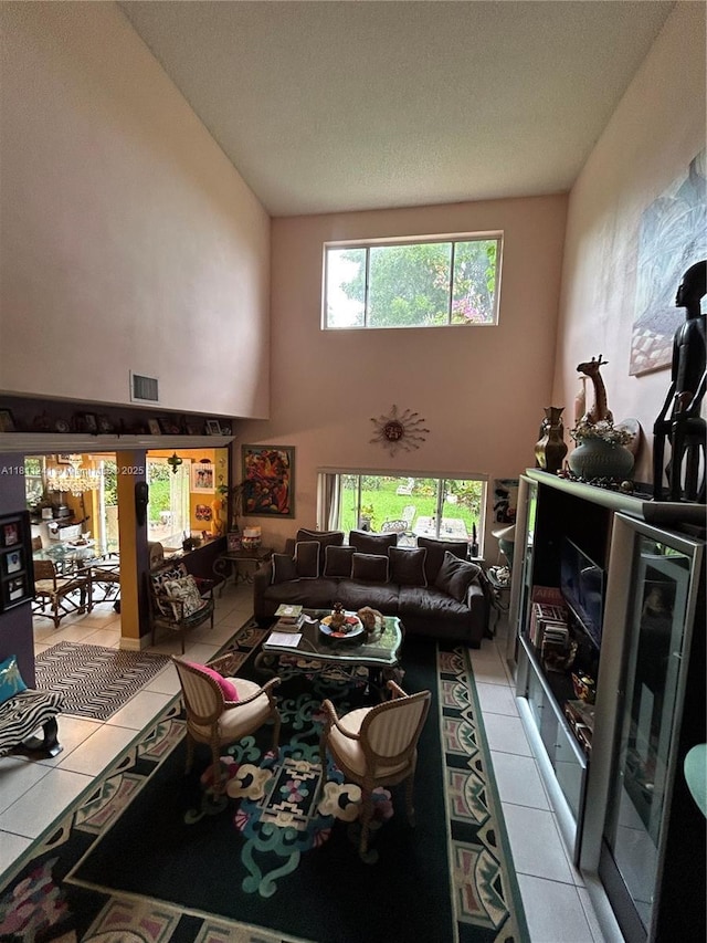 11920 SW 20th St, Miramar, FL 33025 - living area featuring light tile patterned floors, a high ceiling, and a textured ceiling