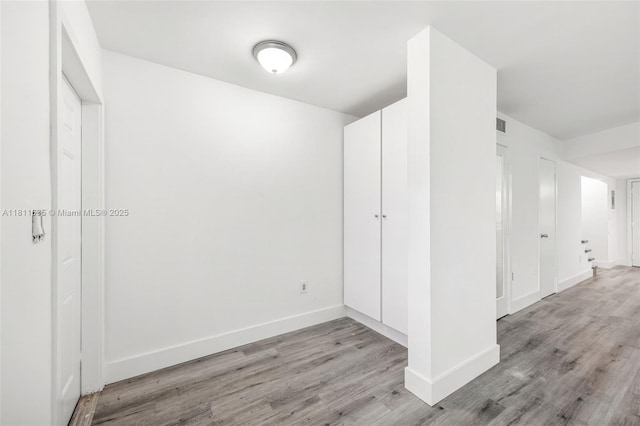 1461 NE 150th St Unit 103, Miami, FL 33161 - unfurnished bedroom with light wood-style floors and baseboards