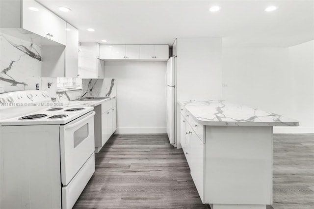 1461 NE 150th St Unit 103, Miami, FL 33161 - kitchen with white appliances, a peninsula, white cabinetry, recessed lighting, and light wood finished floors