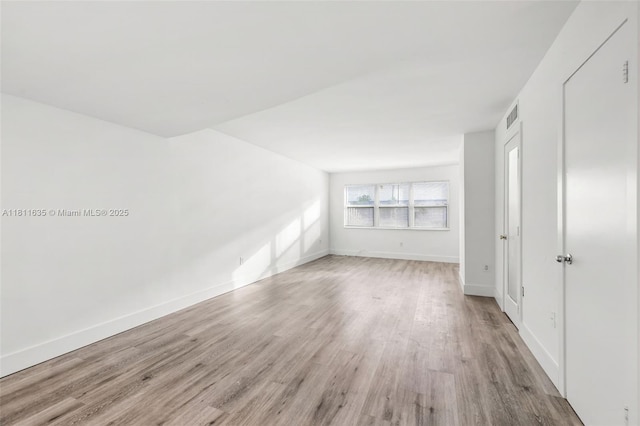 1461 NE 150th St Unit 103, Miami, FL 33161 - unfurnished room featuring wood finished floors and baseboards