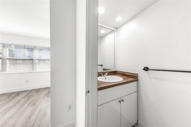 1461 NE 150th St Unit 103, Miami, FL 33161 - bathroom featuring vanity, wood finished floors, baseboards, and recessed lighting
