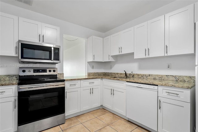 2500 SW 81st Ave Unit 402, Davie, FL 33324 - kitchen with appliances with stainless steel finishes, a sink, white cabinetry, and light stone counters