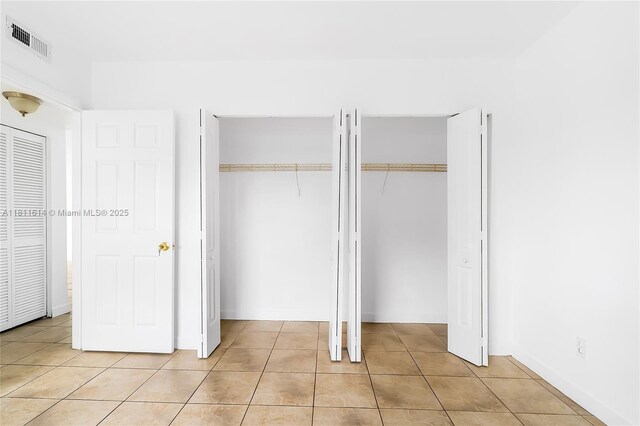 2500 SW 81st Ave Unit 402, Davie, FL 33324 - unfurnished bedroom with light tile patterned floors and two closets