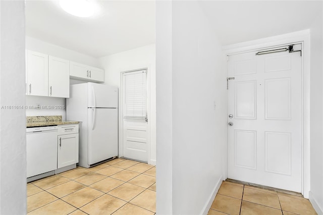 2500 SW 81st Ave Unit 402, Davie, FL 33324 - kitchen featuring white appliances, light tile patterned flooring, white cabinetry, and baseboards