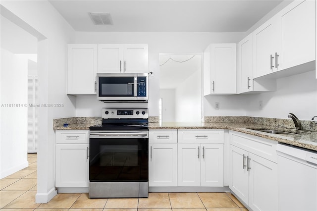 2500 SW 81st Ave Unit 402, Davie, FL 33324 - kitchen featuring stainless steel appliances, a sink, white cabinets, and light stone counters