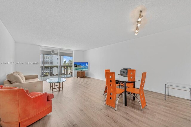 500 NE 12th Ave Unit 407, Hallandale Beach, FL 33009 - dining space featuring a textured ceiling, light wood-style floors, ceiling fan, and baseboards