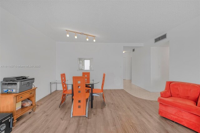 500 NE 12th Ave Unit 407, Hallandale Beach, FL 33009 - dining room with light wood-style floors and a textured ceiling
