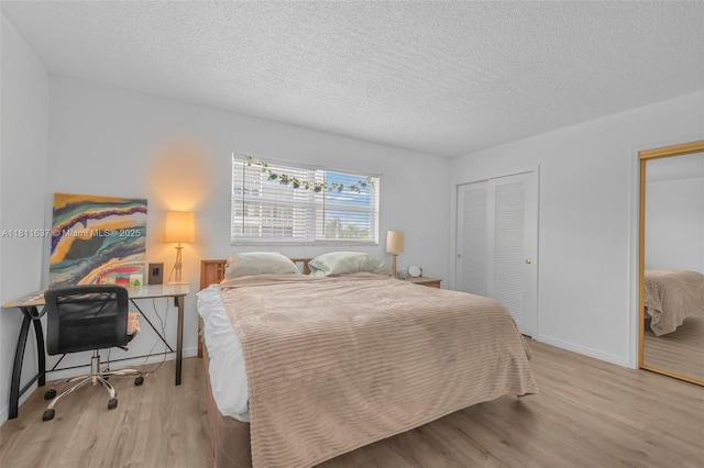 500 NE 12th Ave Unit 407, Hallandale Beach, FL 33009 - bedroom with wood finished floors, two closets, a textured ceiling, baseboards, and an office area