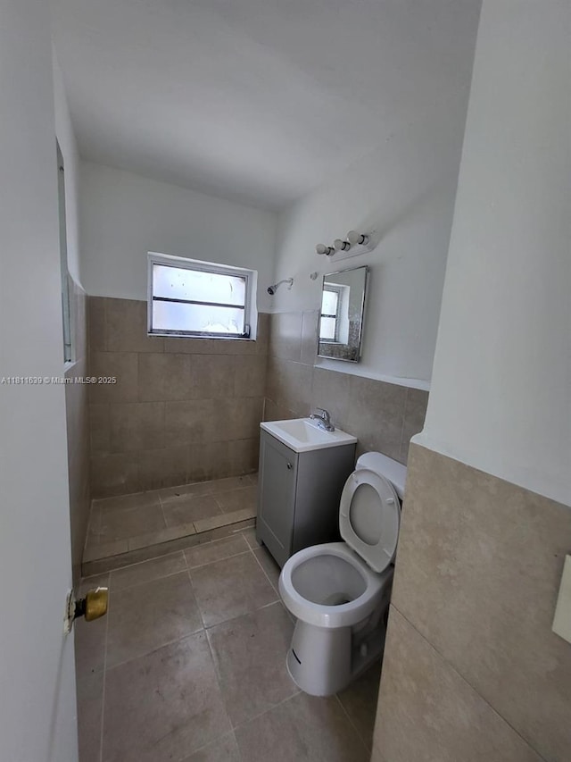 640-642 NW 77th St, Miami, FL 33150 - bathroom with toilet, tile walls, tile patterned flooring, a tile shower, and vanity