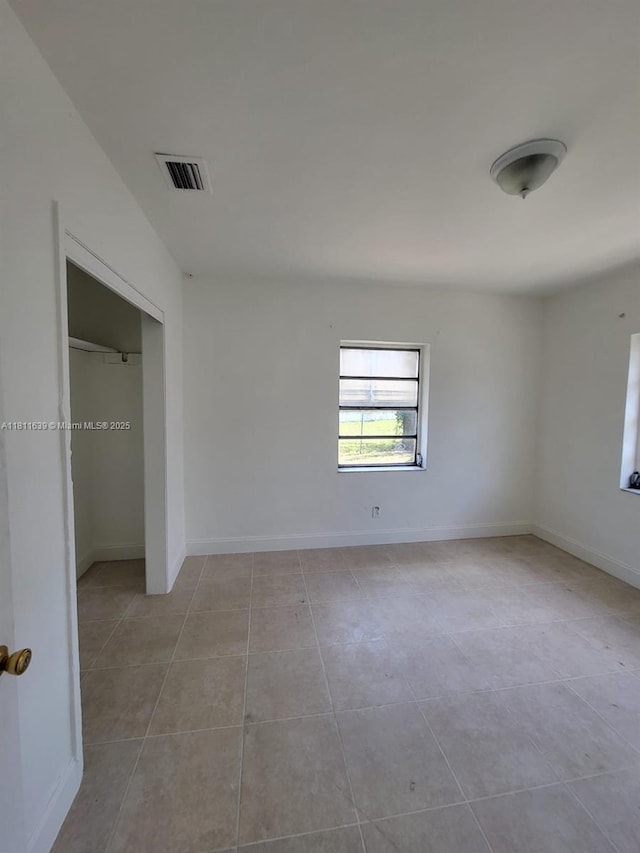 640-642 NW 77th St, Miami, FL 33150 - unfurnished bedroom with tile patterned floors, baseboards, and a closet