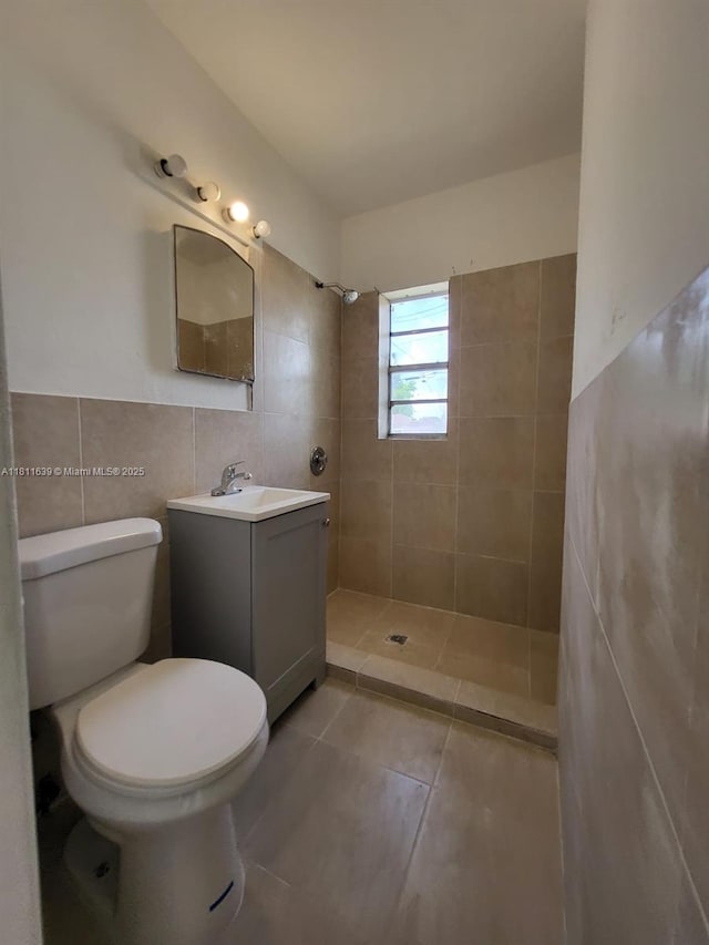 640-642 NW 77th St, Miami, FL 33150 - bathroom with tile walls, a tile shower, vanity, toilet, and tile patterned flooring