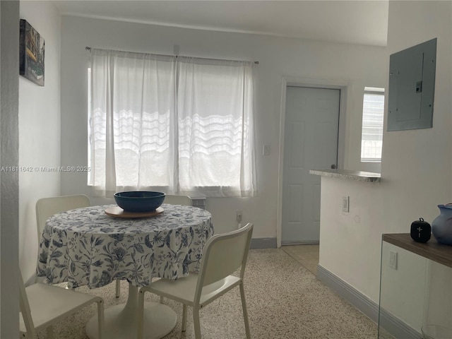 865 80th St, Miami Beach, FL 33141 - dining space with electric panel, baseboards, and dark speckled floor