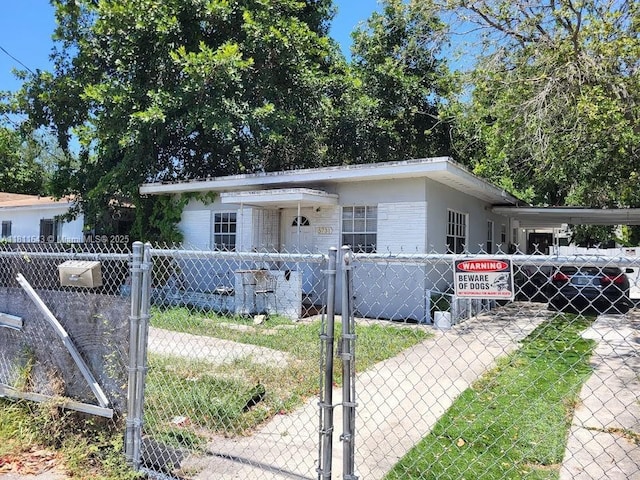 5731 NW 6th Ave, Miami, FL 33127 - view of front of property featuring a fenced front yard, a gate, an attached carport, and driveway