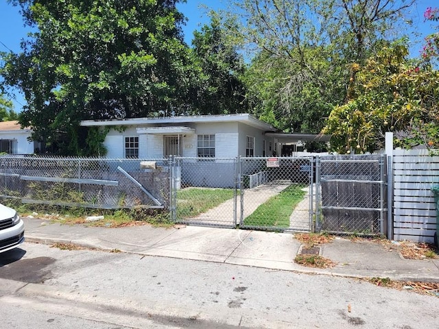5731 NW 6th Ave, Miami, FL 33127 - view of front facade featuring a fenced front yard, a gate, and driveway
