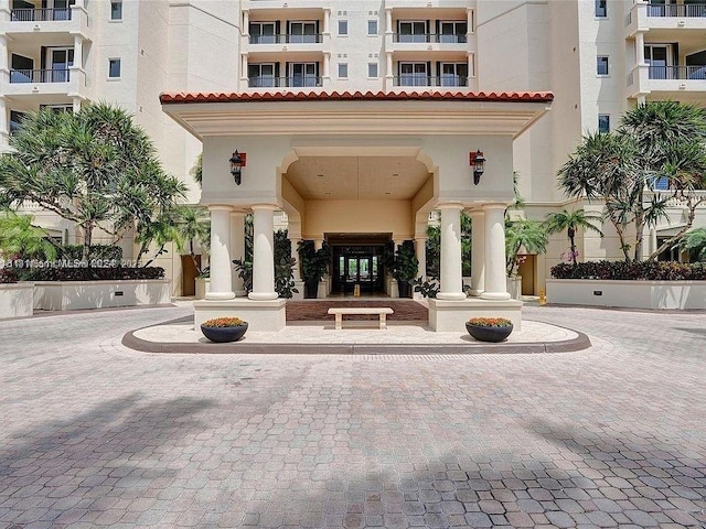 13627 Deering Bay Dr Unit 402, Coral Gables, FL 33158 - view of exterior entry with a tiled roof and stucco siding